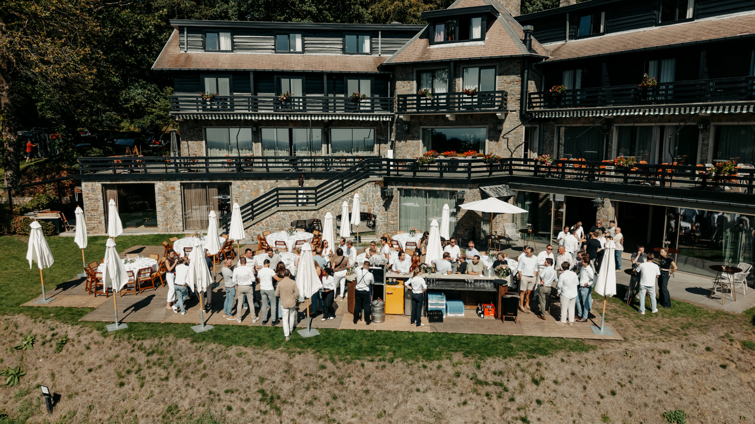 Deelnemers aan de AE-Tour 2026 van AEcars tijdens een exclusief evenement op een zonnig terras